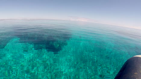 pov moving towards navigation light over submerged reef handheld slomo