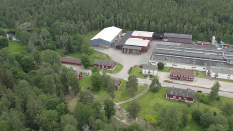 bäckefors bruk with factories, red houses, and surrounding nature, aerial view