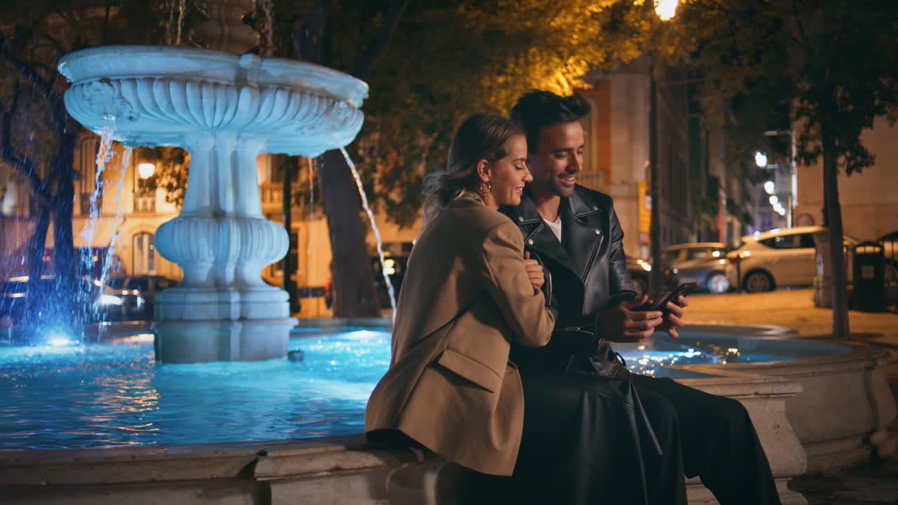 Date people talking city street at night. Happy loving man kissing girlfriend