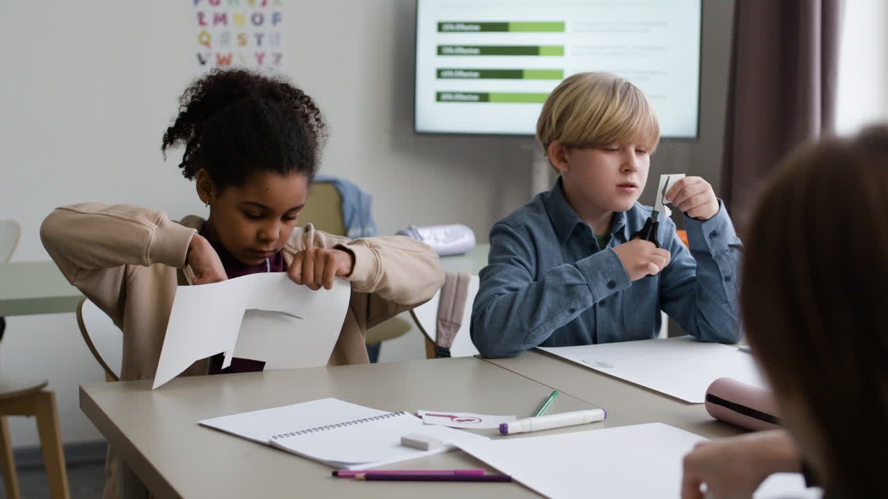 Children Cutting Paper in a Classroom