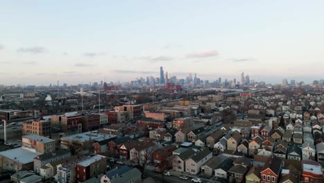 aerial view of the bridgeport neighborhood and the stevenson expressway, winter sunrise in chicago, usa - ascending, drone shot