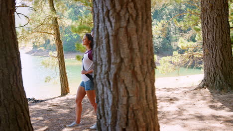 Couple-On-Countryside-Hike-Walking-Through-Woods-By-Lake