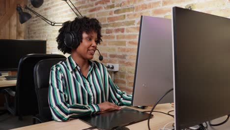 a woman is working in the office at the computer