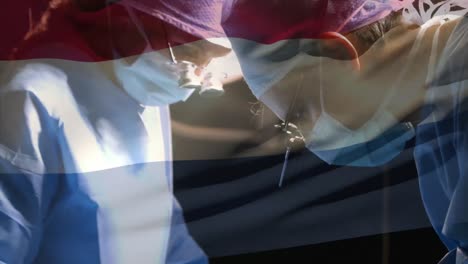 animación de la bandera de los países bajos ondeando sobre los cirujanos en el quirófano