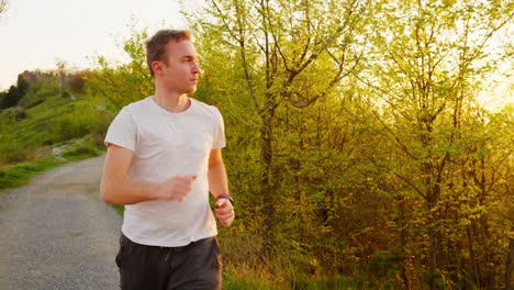 young man running through a scenic forest path during sunset, vibrant golden light