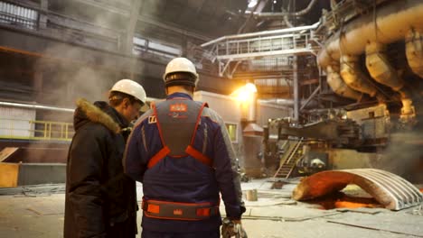 trabajadores de la fábrica de acero inspeccionando las operaciones