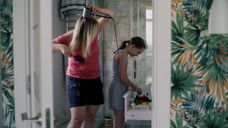 mother and daughter getting ready in the bathroom