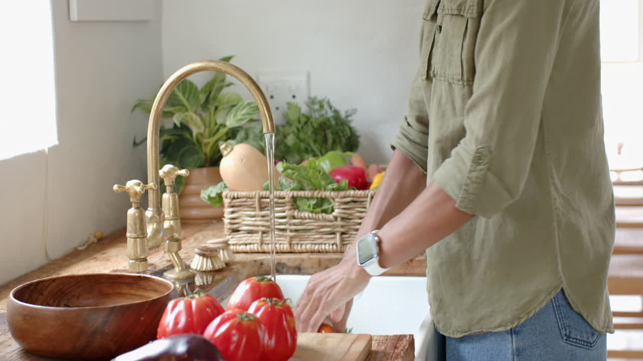 Washing fresh vegetables in kitchen, preparing healthy meal with focus and care, at home