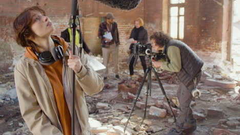 two production co workers getting ready to record in a ruined building 1