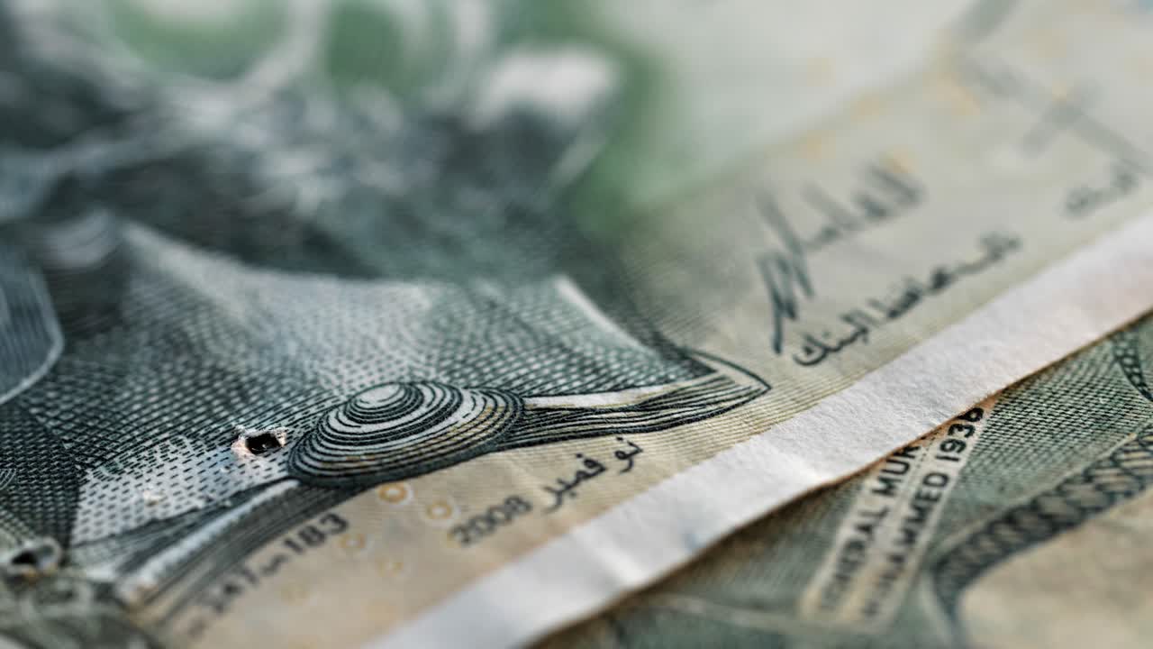 Static macro shot of various international banknotes falling into frame