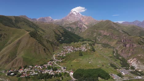 forward drone shot above gergeti, stepantsminda village