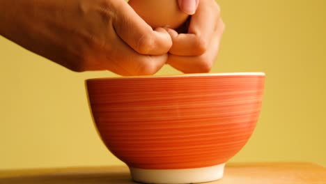 breaking egg to bowl