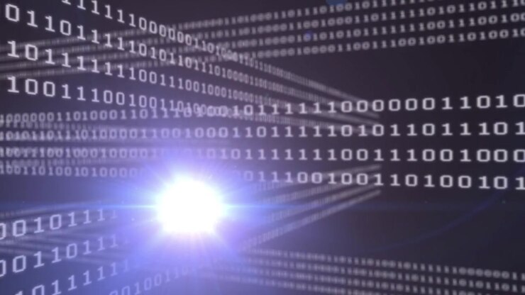 This video shows a grid of binary code that is glowing and flickering in different colors