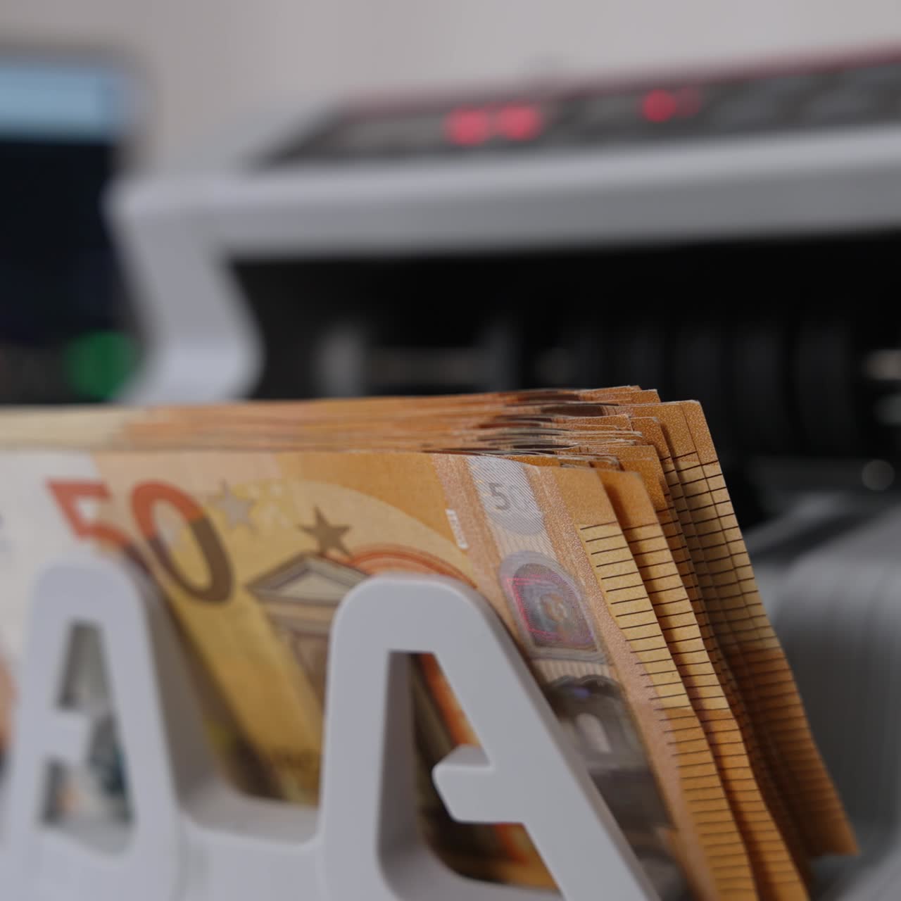 Starting a cash counting machine. European currency being calculated in the equipment. Financial operations concept
