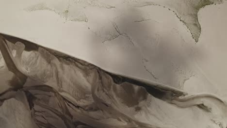 aerial top-down shot of the drying riverbed due to the drought caused by global warming and water shortage in europe