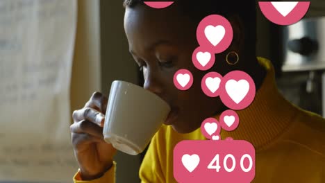 Animation-of-social-media-heart-icons-and-numbers-over-woman-drinking-coffee