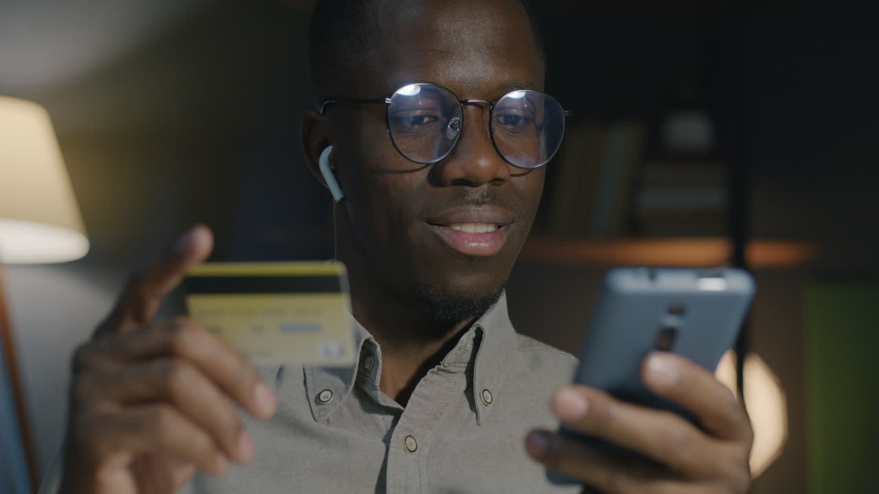Man Using Smartphone and Credit Card for Online Shopping