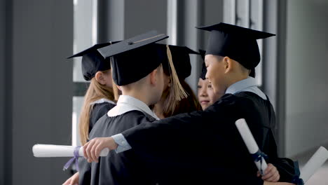 group of happy  preschool students in mortarboard and gown 8