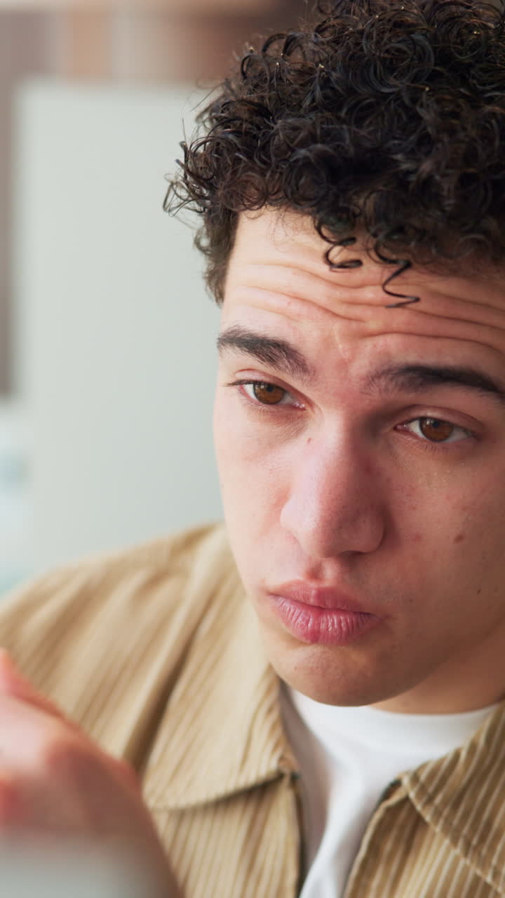 Young Man Rubbing Tired Eyes and Putting on Glasses