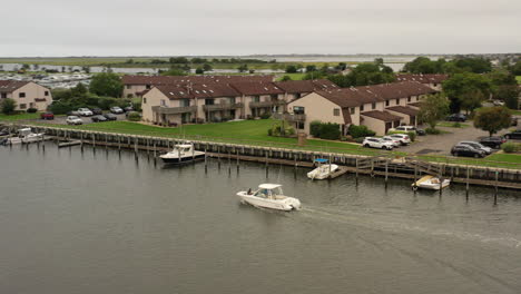 An-aerial-view-of-a-fishing-boat-sailing-in-Freeport,-NY