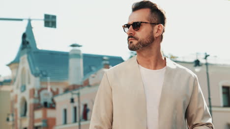 man in a beige jacket and sunglasses