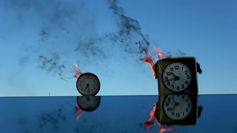 time is a fire. burning  old  alarm clocks on mirror