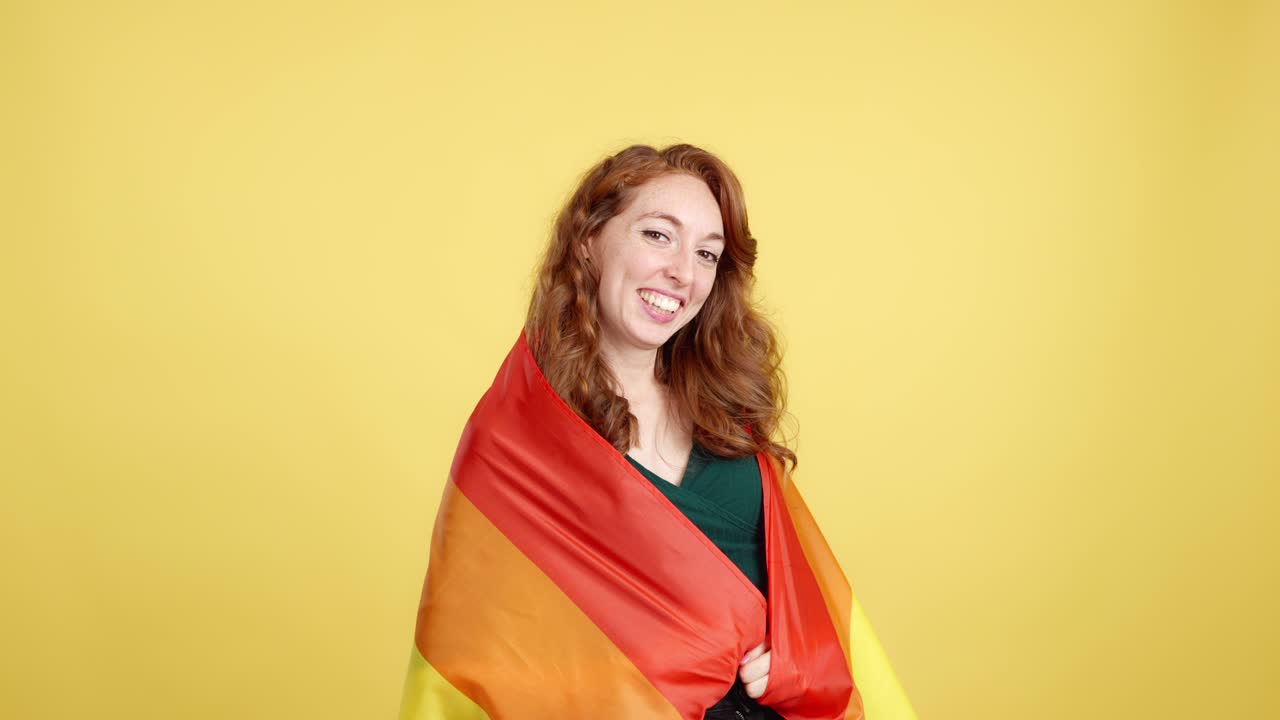 Happy Woman Wrapped in Rainbow Pride Flag