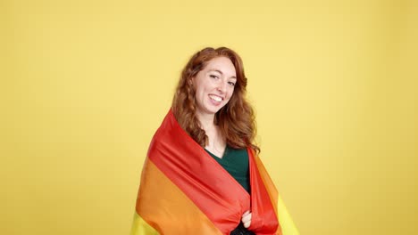 happy woman wrapped in rainbow pride flag