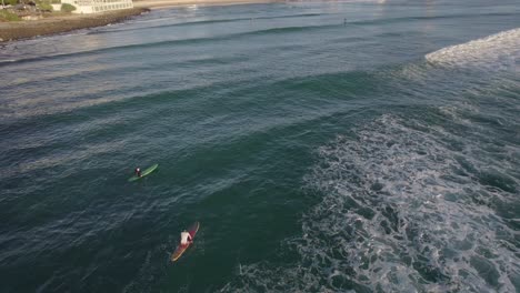 Surfers-In-Burleigh-Beach-In-Queensland,-Australia---aerial-drone-shot