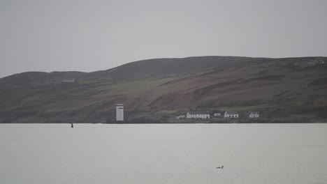 Distant-Carraig-Fhada-Lighthouse,-Islay-Lighthouse.-Haze.-Static