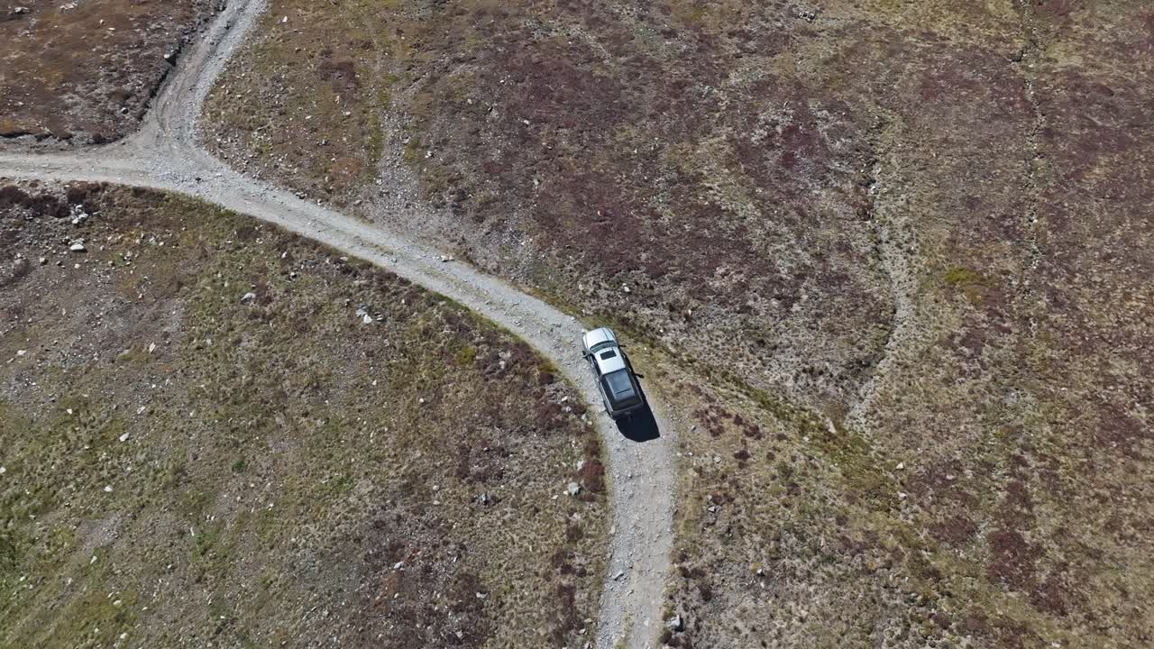 Top down tilt up aerial of truck driving along dirt road of Peak 10 trail Breckenridge Colorado