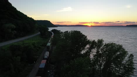 sunset over river with train