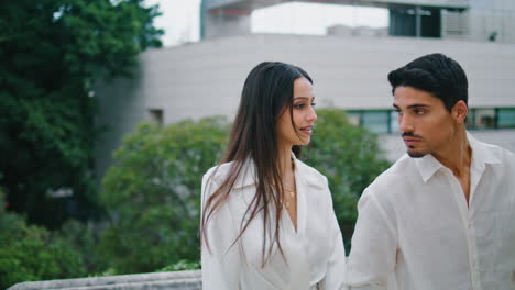 Relaxed-couple-strolling-stairs-outdoors.-Hispanic-stylish-pair-walking-street