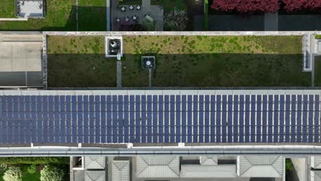 Top-down-aerial-shot-of-solar-panels-and-green-roof-on-futuristic-clean-building