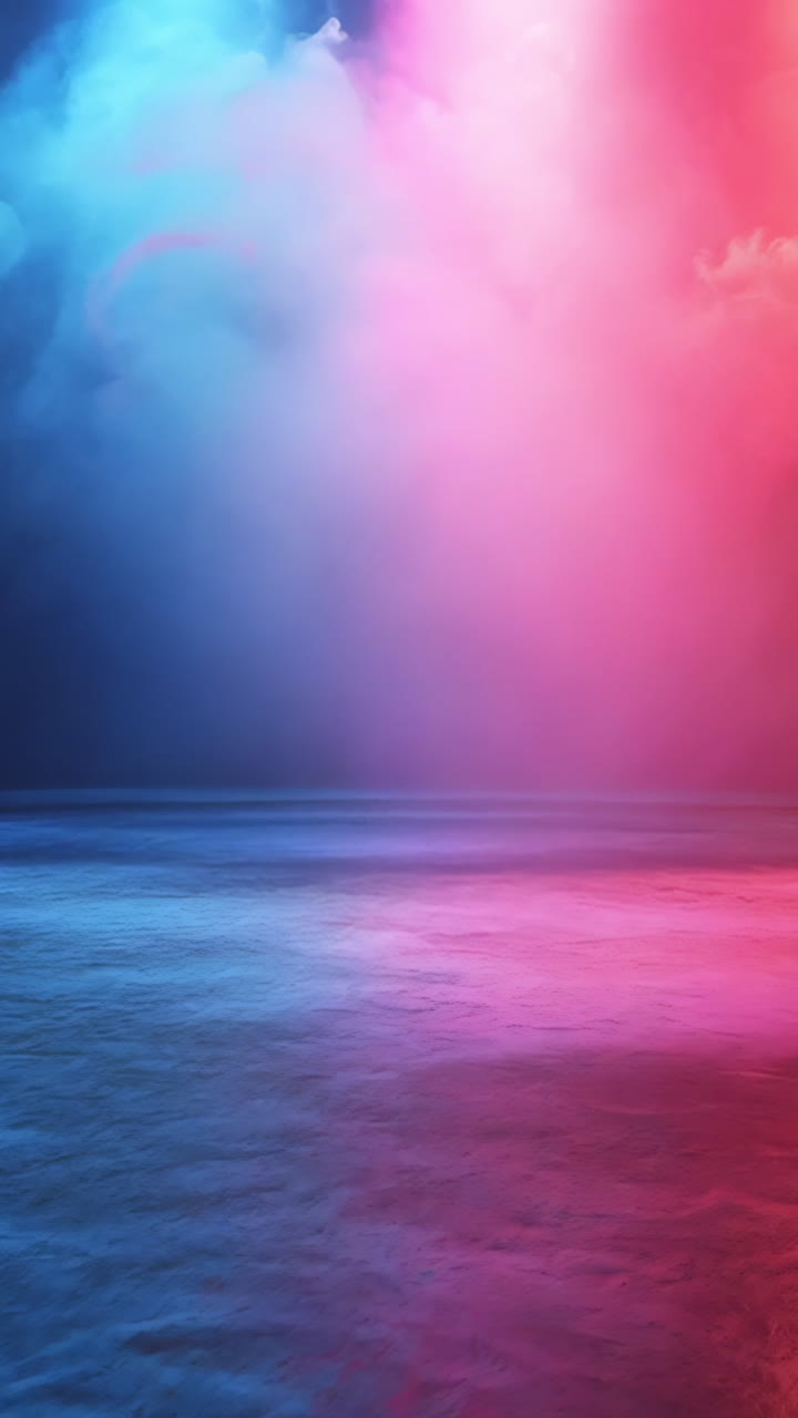 A stage with lights and smoke in the background. The lights are red, blue, and purple