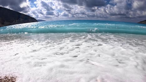 sunlit crystal blue sea surrounding white pebble shores of myrtos beach, kefalonia