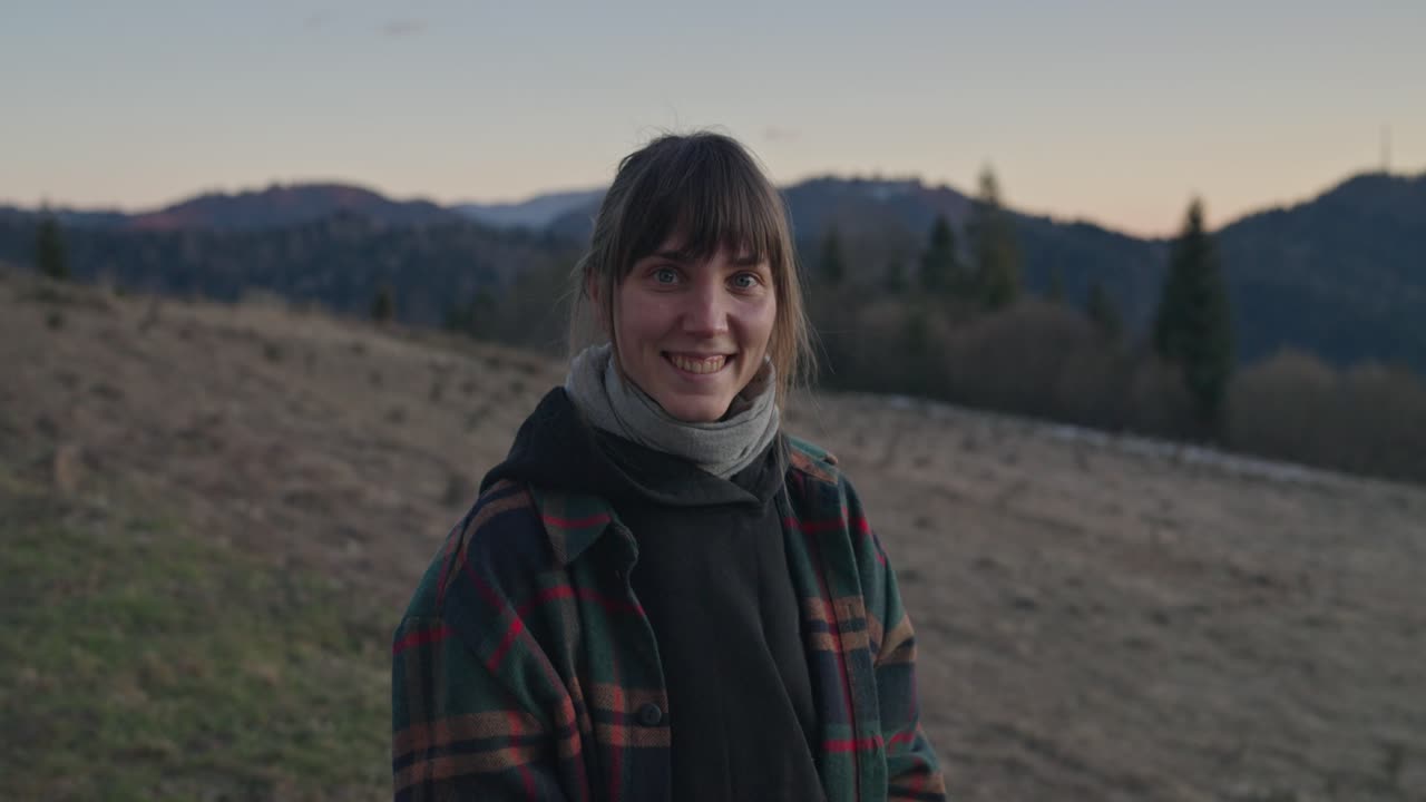 Portrait of a smiling woman in the mountains