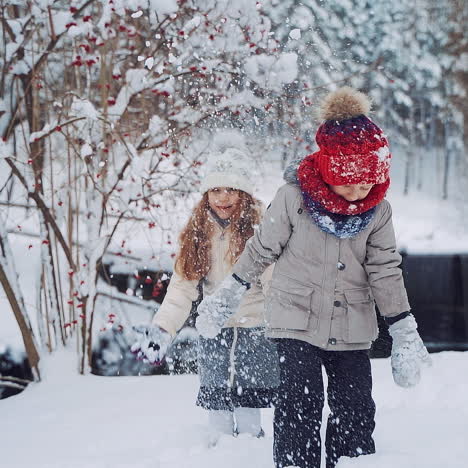 happy kids playing together with snow. christmas vacation in sunny winter park. slow motion.