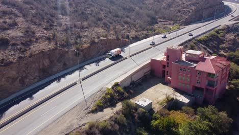 Aerial-drone-view-towards-traffic-on-a-highway,-in-sunny-Al-baha,-Saudi-Arabia