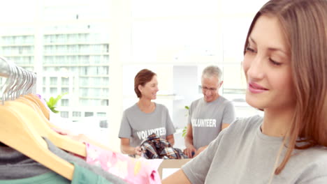 smiling young female volunteer separating clothes