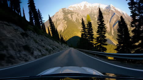driving on a scenic mountain road with a view of snow-capped peaks
