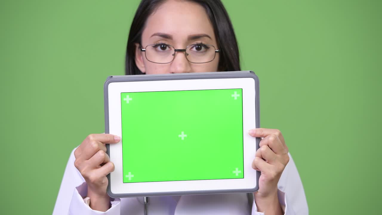 Young beautiful Asian woman doctor showing digital tablet