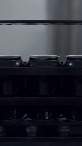 black cans on an industrial production line