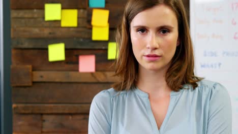 portrait of business executive standing with arms crossed