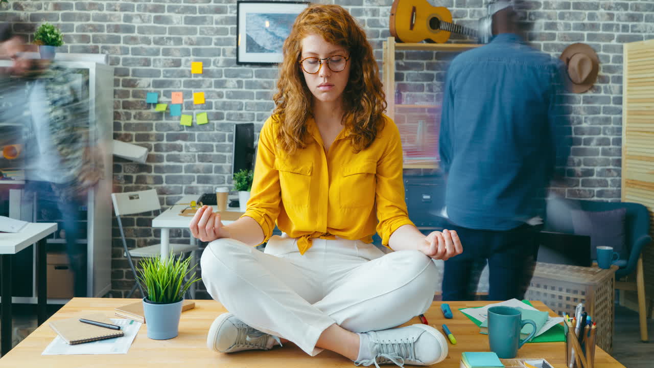 Woman meditating at her office desk