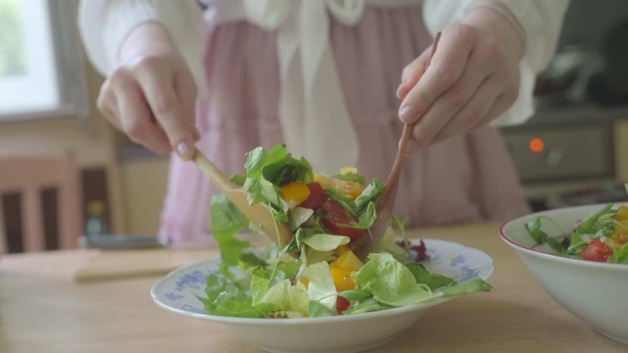 Wooden spoons, like dancers, waltz through delicious and healthy salad mix
