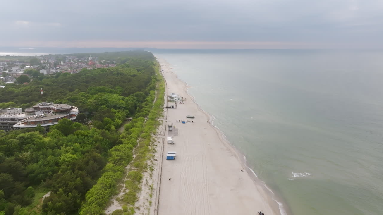 Aerial view backwards over a beach in the Hel Peninsula, stormy evening in Poland