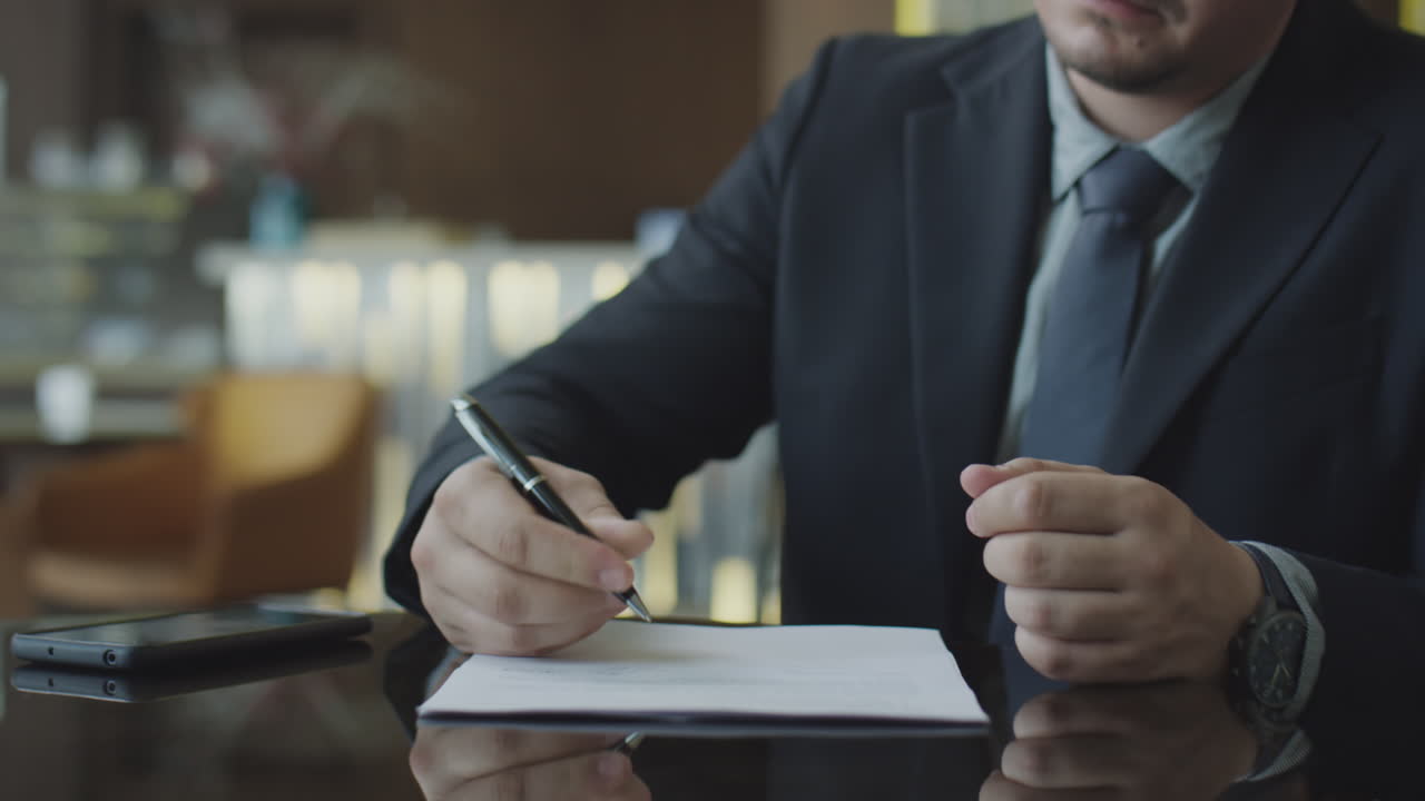 Businessmen Shaking Hands after Signing Contract