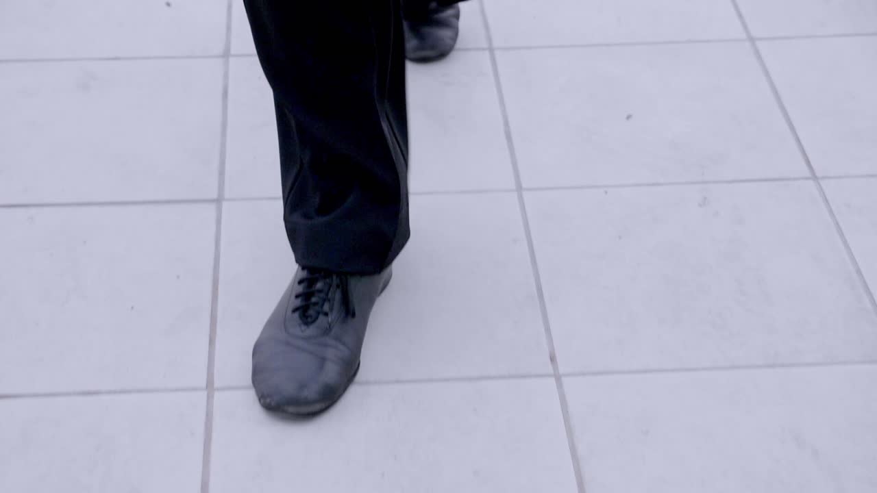 Person walking on a tiled floor