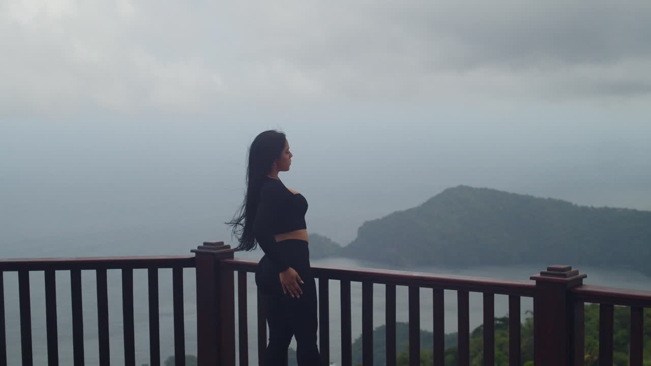 A young Latina embracing the breathtaking tropical panorama from the scenic La Vigie Lookout
